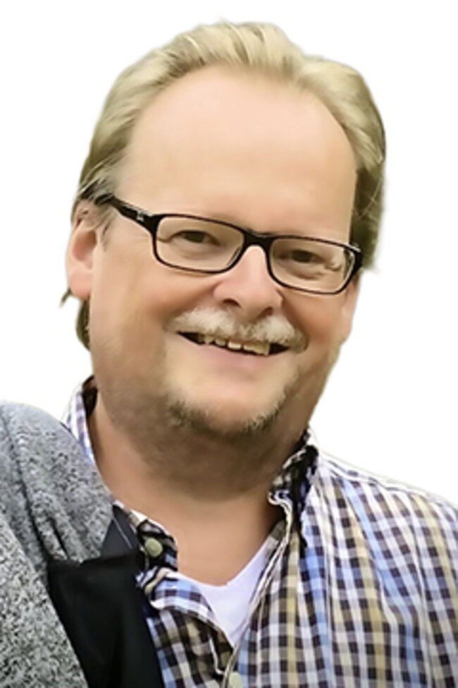 Portrait eines lächelnden Mannes.