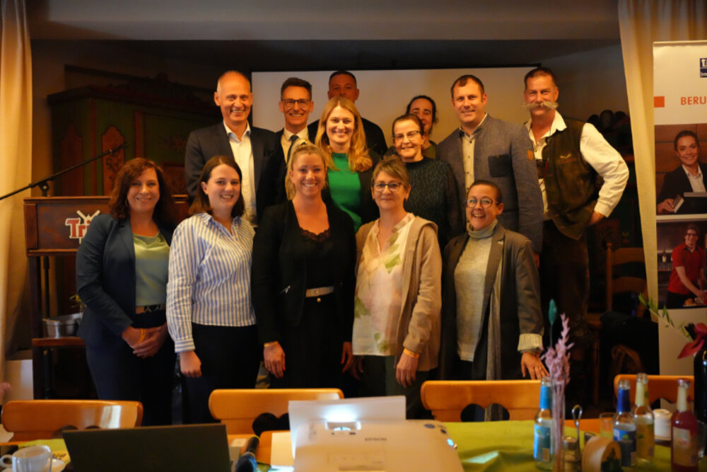 Ein Gruppenfoto in einer Gaststätte von vielen Frauen und Männern.